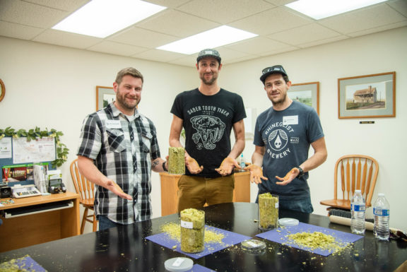 three men with hops on their hands