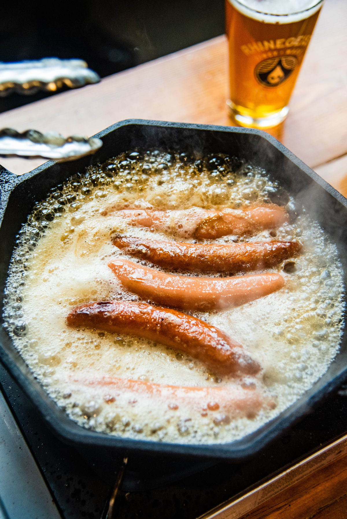 hot dogs braising in Rhinegeist Hustle IPA