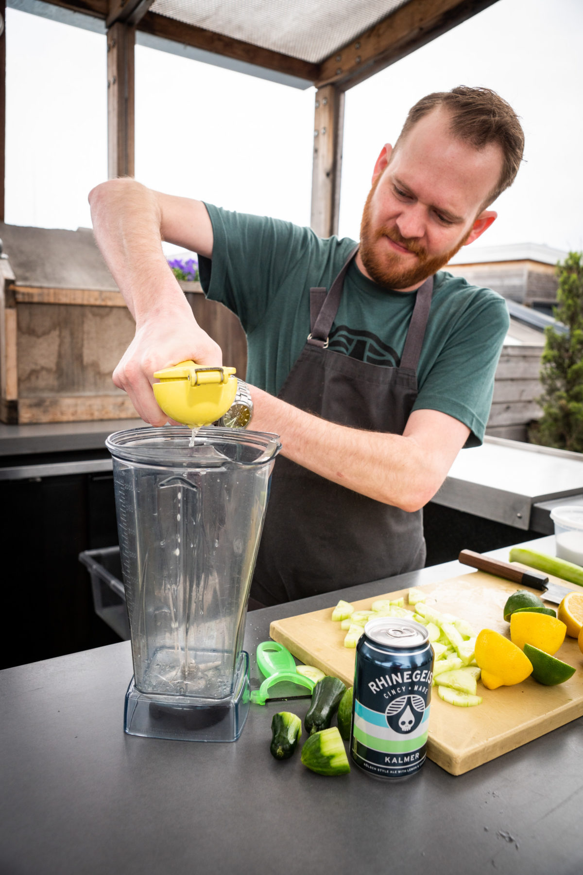 Chef juicing lemon into blender