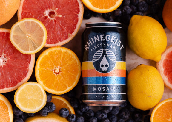 Rhinegeist Mosaic Pale Ale can next to fruit