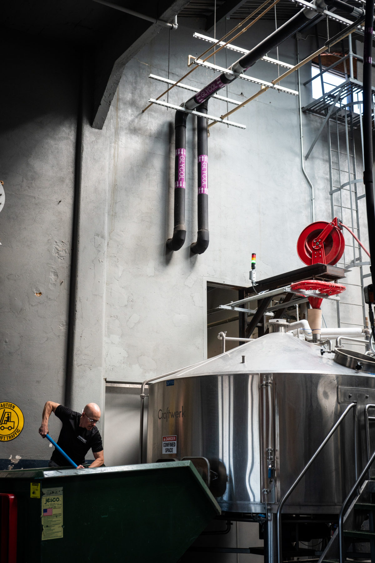 Jim shoveling grain at Rhinegeist