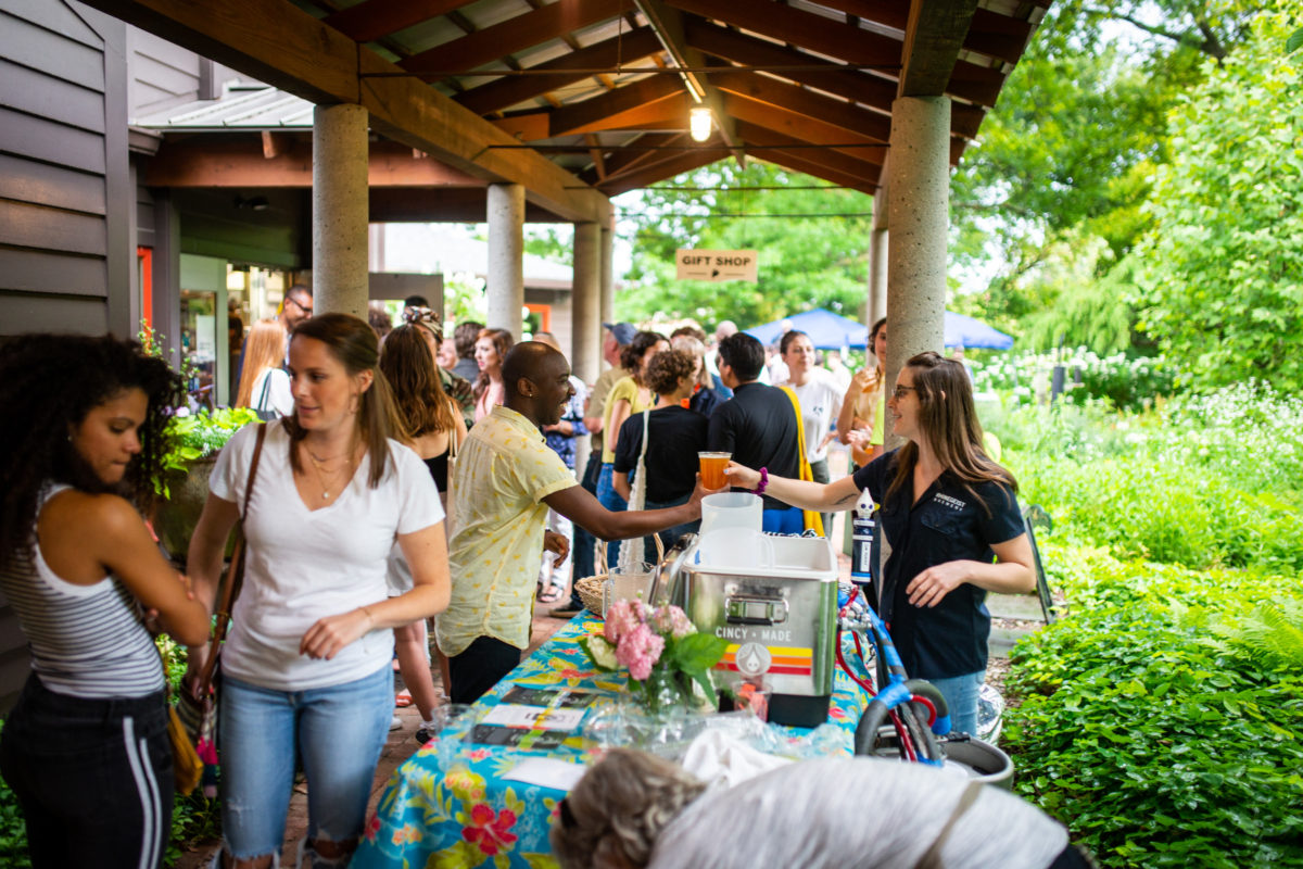 Woman serving beer to man at Civic Garden Center