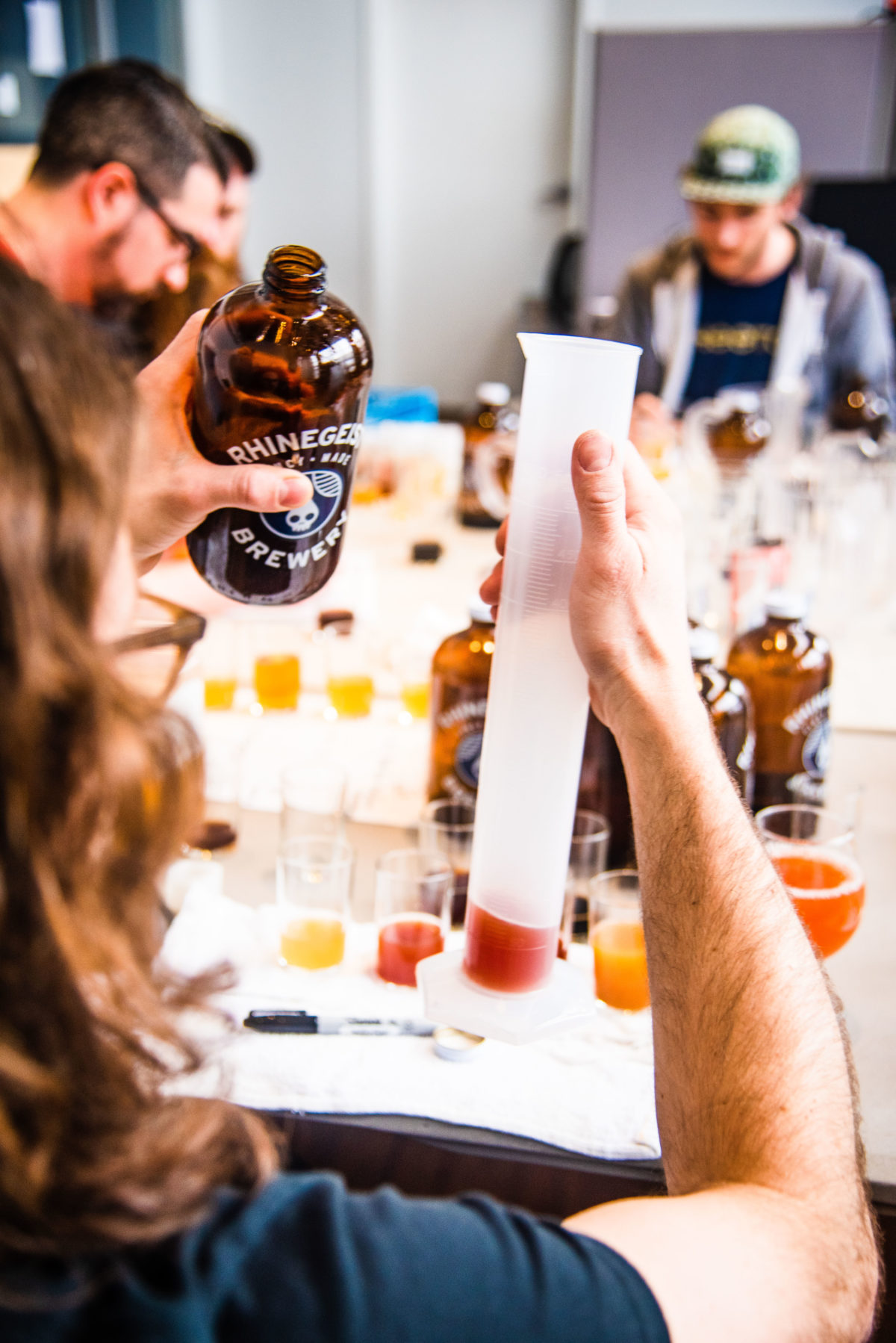 Man holding sample of sour beer at Rhinegeist Brewery