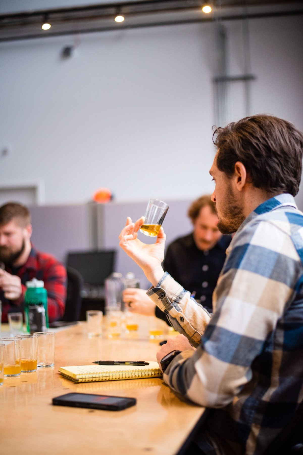 man holding tasting glass of beer