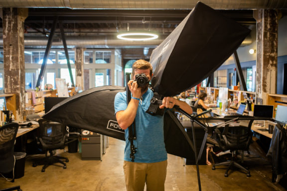 man taking photo while holding lights