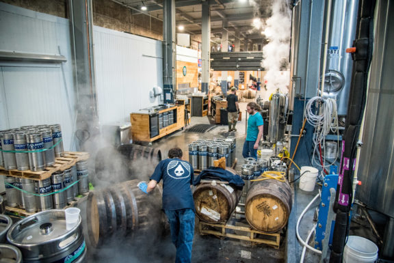 Showing the process of filling barrels with beer at Rhinegeist brewery