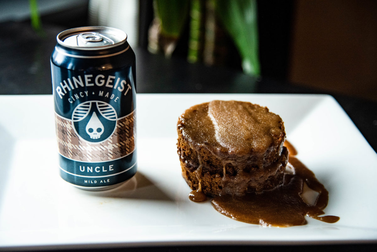 Final dish on plate with can of rhinegeist uncle next to spice cake