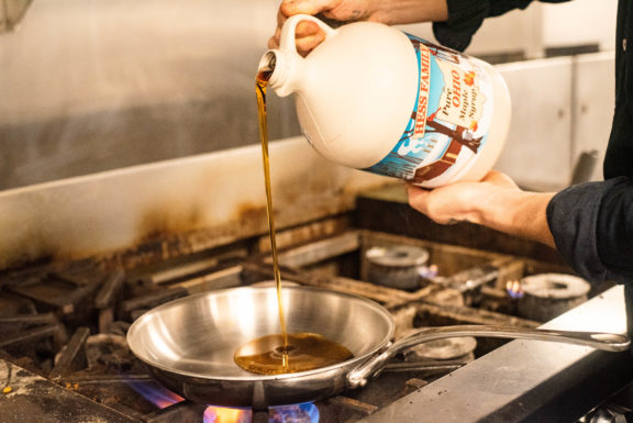 pouring syrup into saucepan for glaze