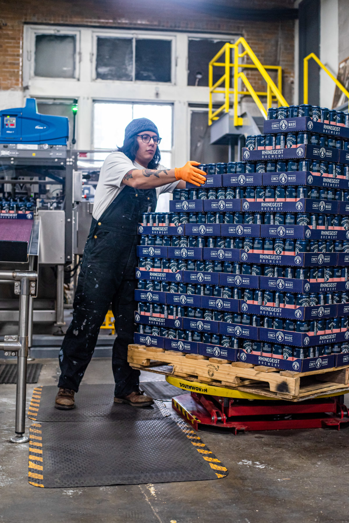 man stacking cases of beer